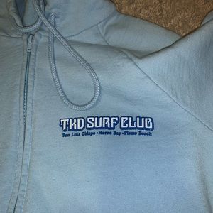 a light blue zip up jacket